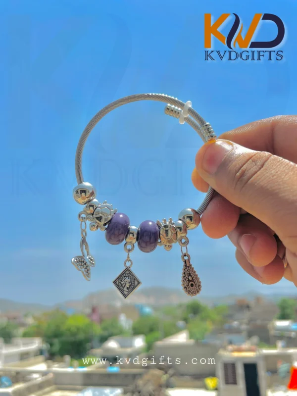 Elegant Silver Charm Bracelet with Purple Beads and Dangling Charms