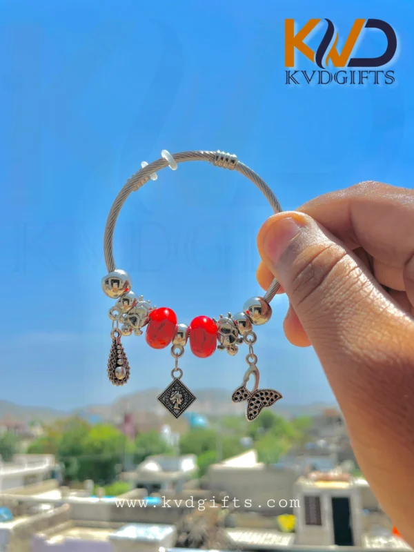 Elegant Silver Charm Bracelet with Red Beads and Dangling Charms