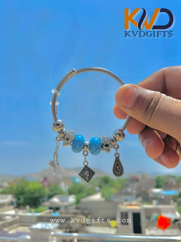 Elegant Silver Charm Bracelet with Sky Blue Beads and Dangling Charms