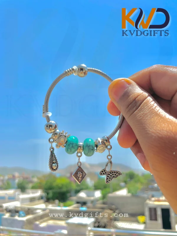 Elegant Silver Charm Bracelet with Sky Blue Beads and Dangling Charms