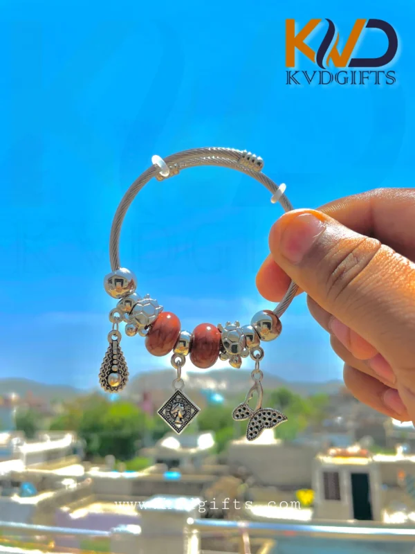 Elegant Silver Charm Bracelet with Brown Beads and Dangling Charms